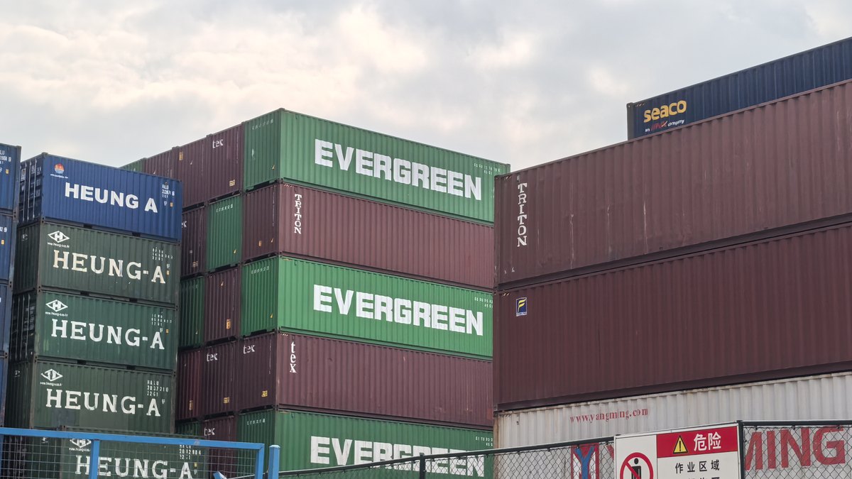 Stacked ocean containers at a Chinese port awaiting loading to Angola