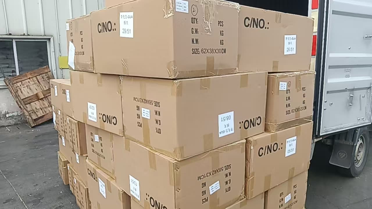 Export cartons carrying shipping marks, stacked on the loading bay of the Nansha consolidation warehouse in Guangzhou
