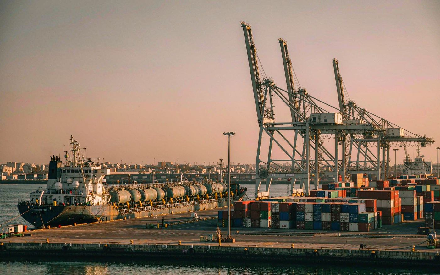 Atlantic African container port with gantry cranes, stacked containers and cargo vessels