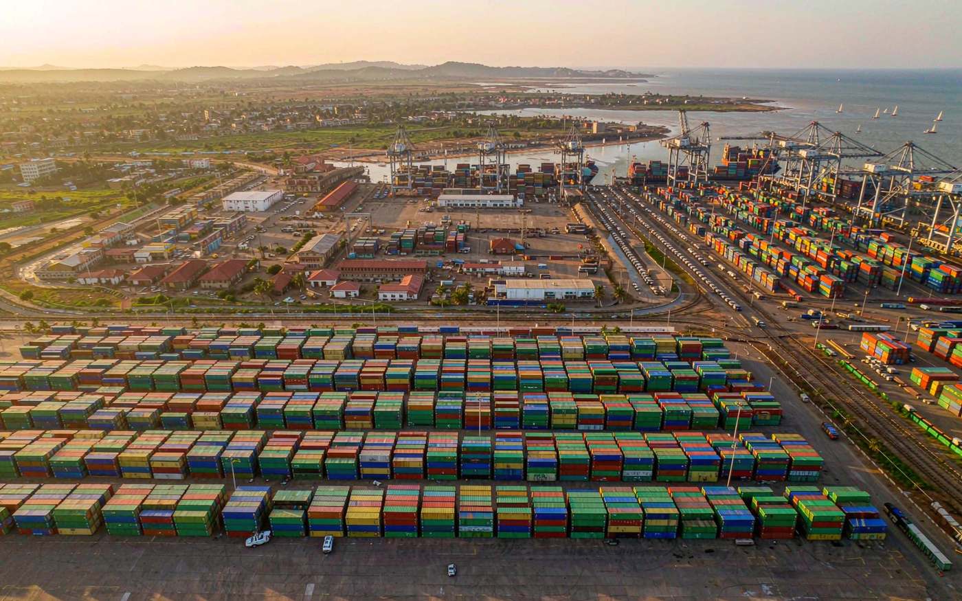 Container terminal at the port of Cotonou in Benin with gantry cranes and a queue of trucks