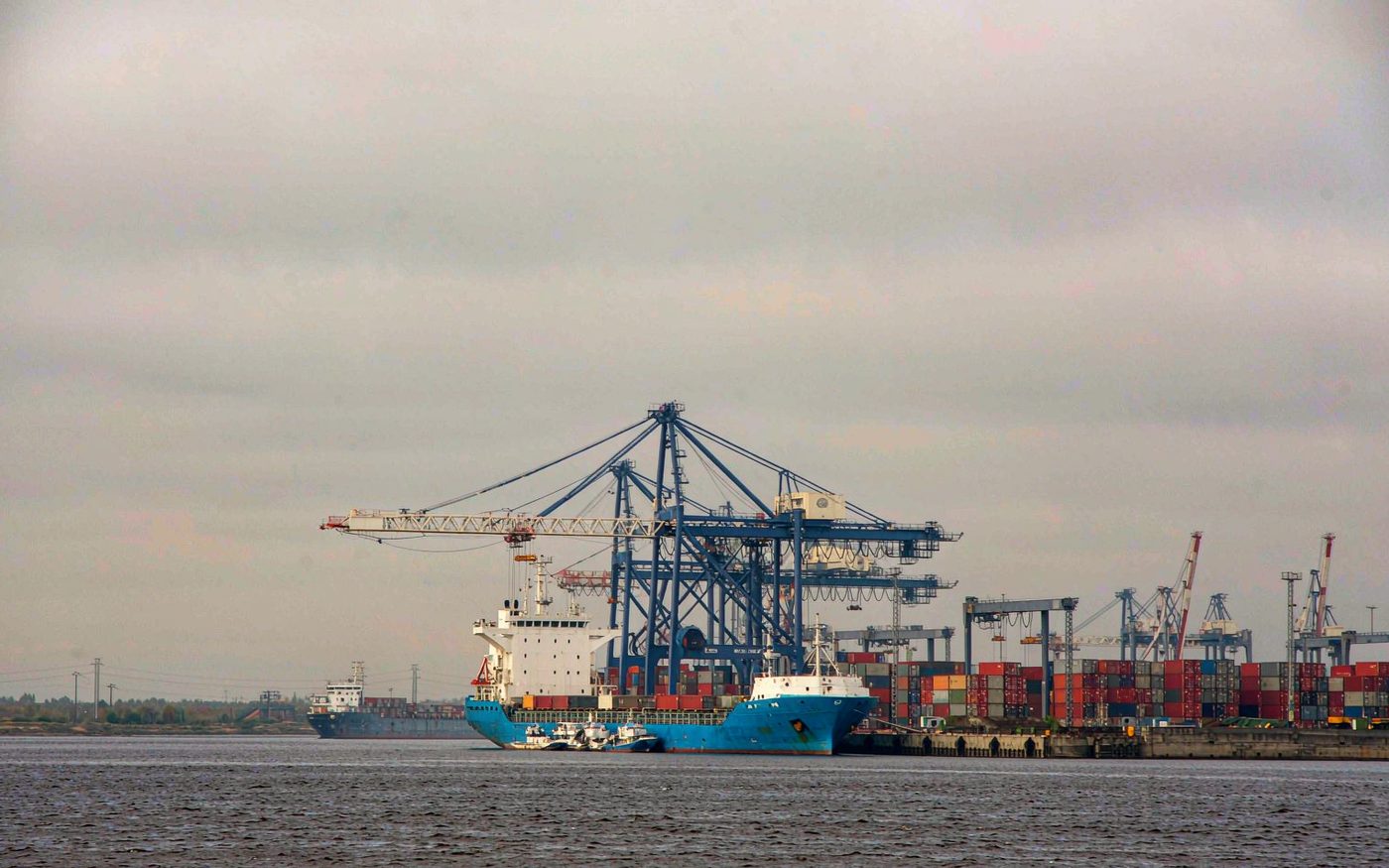 Container cranes and cargo vessels along the quay at the port of Riga in Latvia