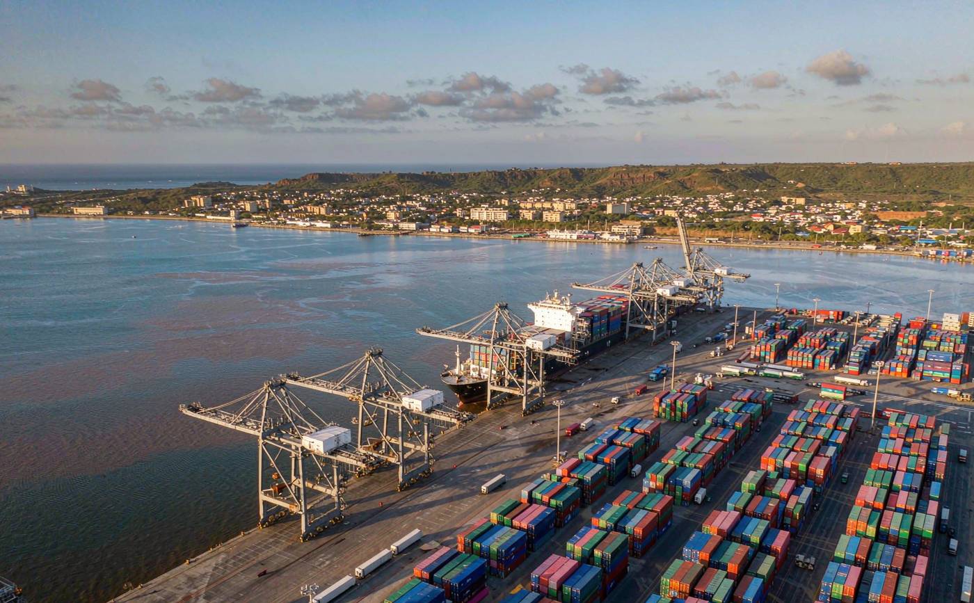 Container terminal on Mexico's Pacific coast, with gantry cranes, stacked containers and a vessel berthed alongside