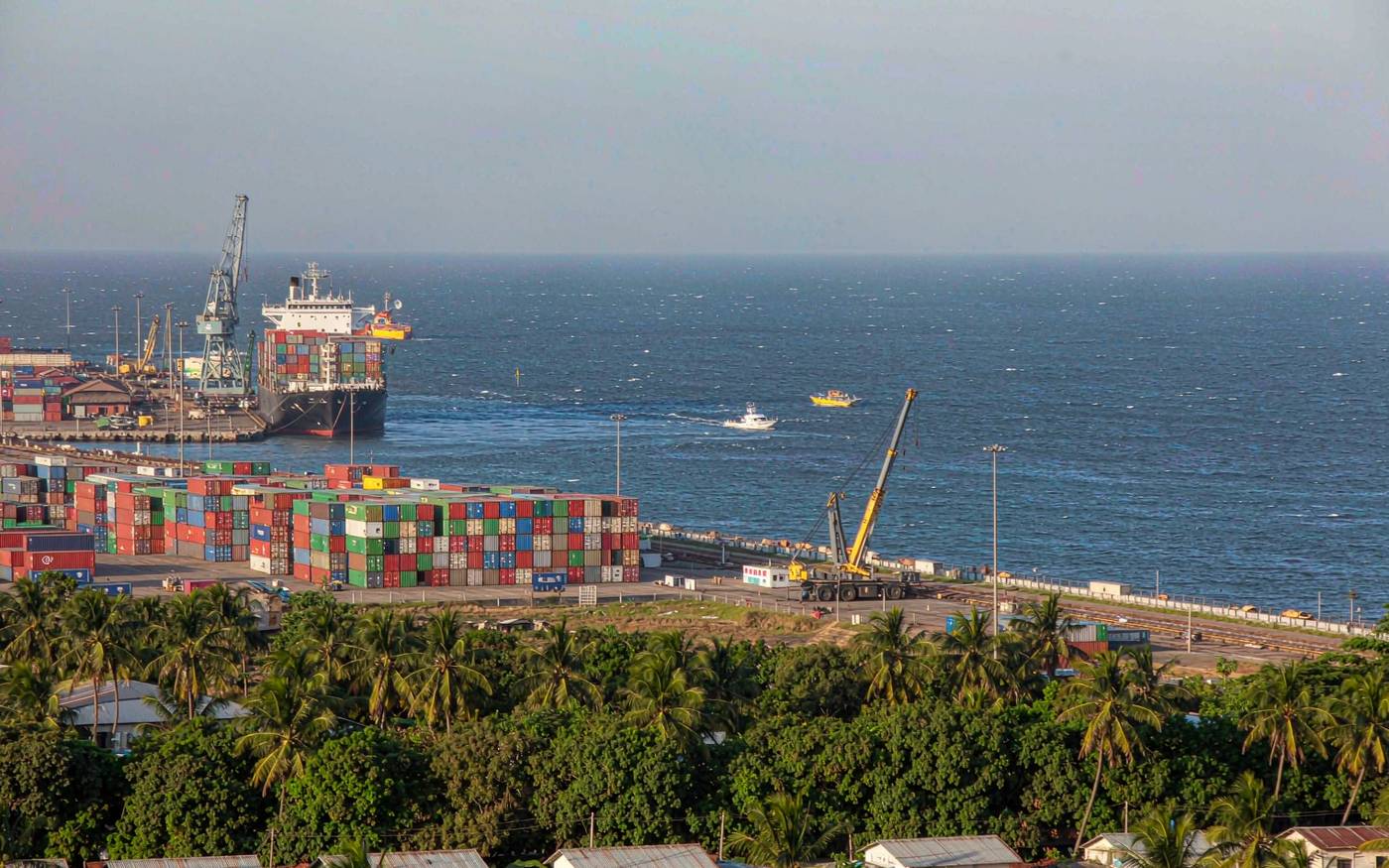 Container terminal at the Port of Maputo in Mozambique with gantry cranes beside a container ship on the Indian Ocean