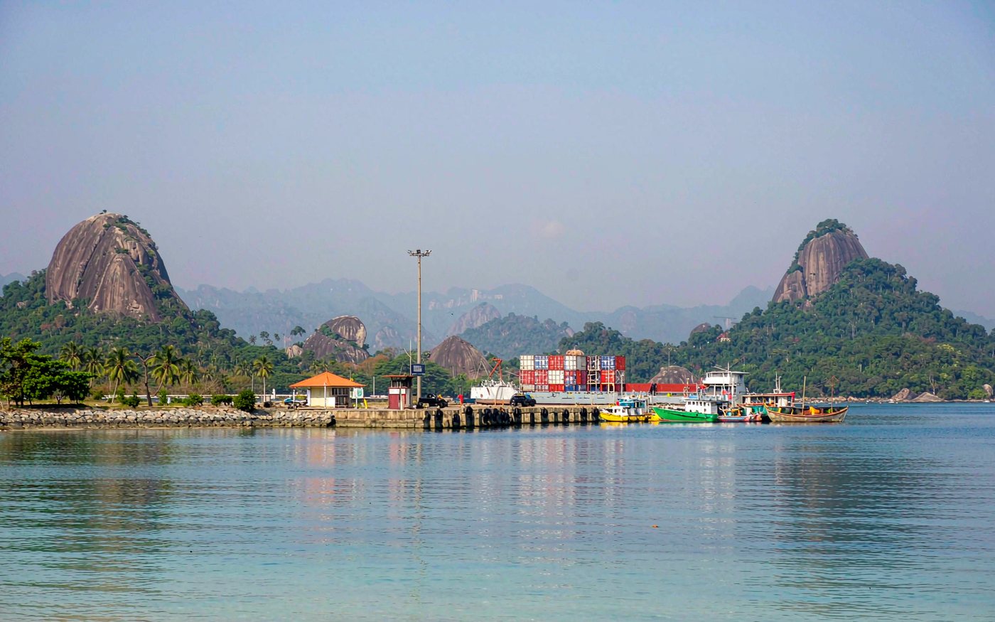 Harbour view of Port Victoria in the Seychelles with moored vessels and tropical islands behind