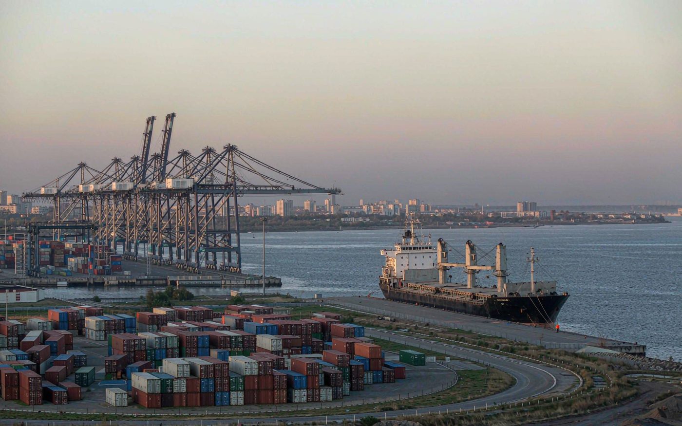 The commercial seaport of Odesa on the Black Sea with container cranes, stacked containers and a cargo ship at berth