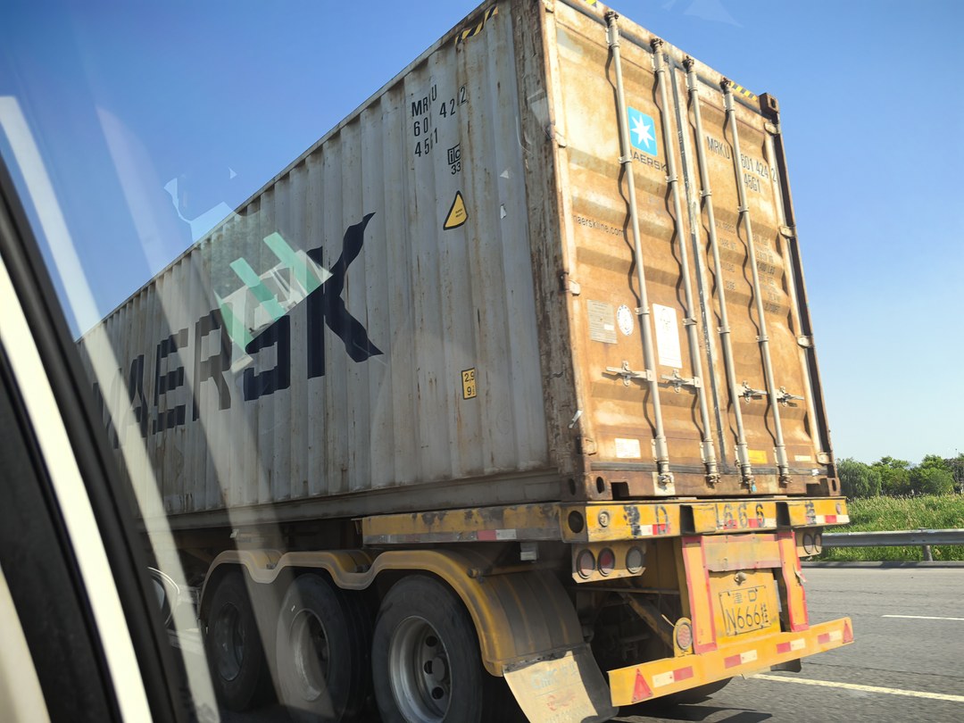 Maersk container truck transporting non-hazardous chemicals from China to the United States via cross-border road freight