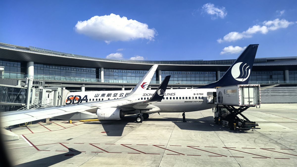 Cargo freighter aircraft at a gate with a belt loader at a Chinese airport &mdash; air freight from Shenzhen to Chicago O'Hare