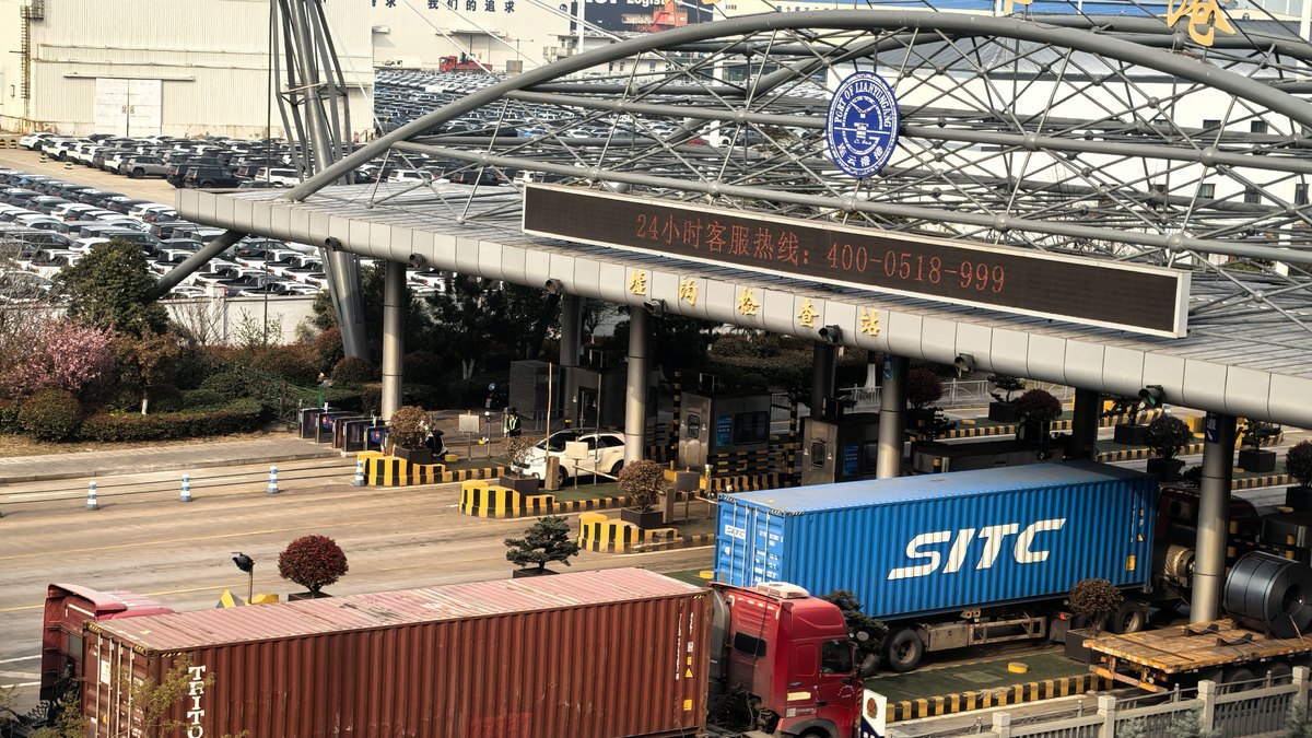 Container truck leaving a Chinese terminal with an ocean-bound box &mdash; the first leg of the short sea run to South Korea