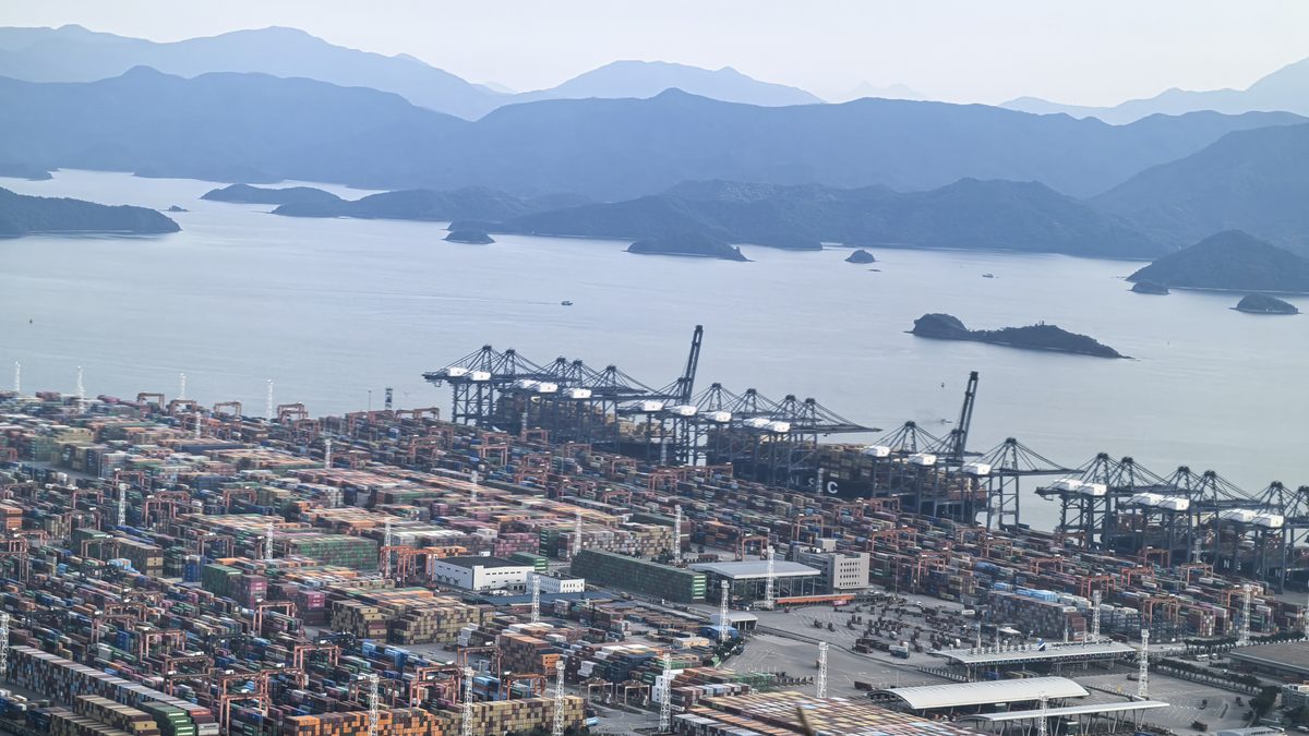 Container ship being loaded with 20GP and 40HQ containers at a Chinese port for a sailing to Felixstowe and Southampton, United Kingdom